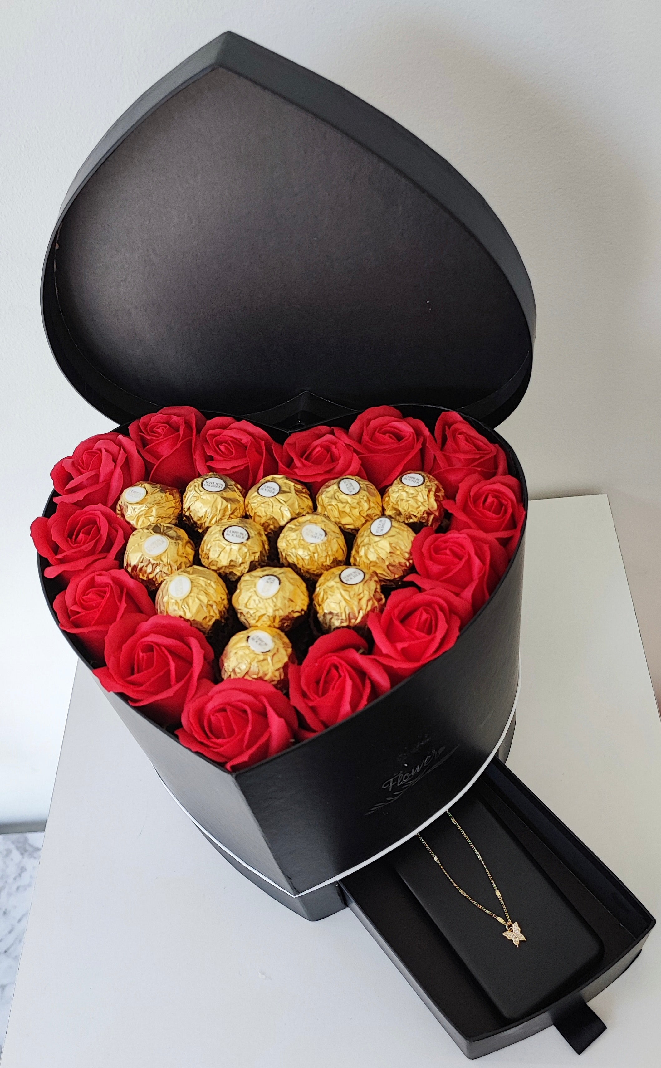 Red roses heart box with necklace and chocolates